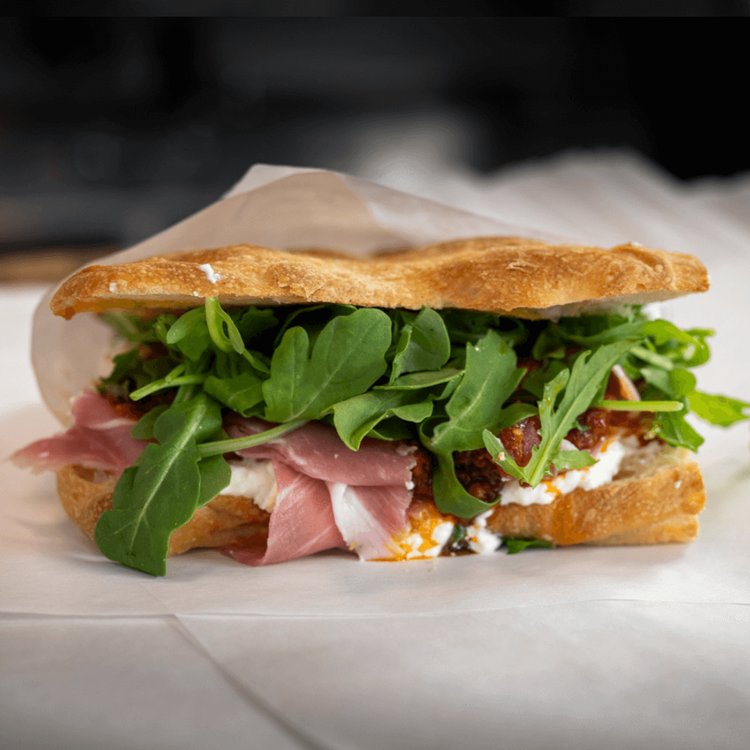 The Bottega — paper-thin prosciutto di Parma with arugula and chili relish