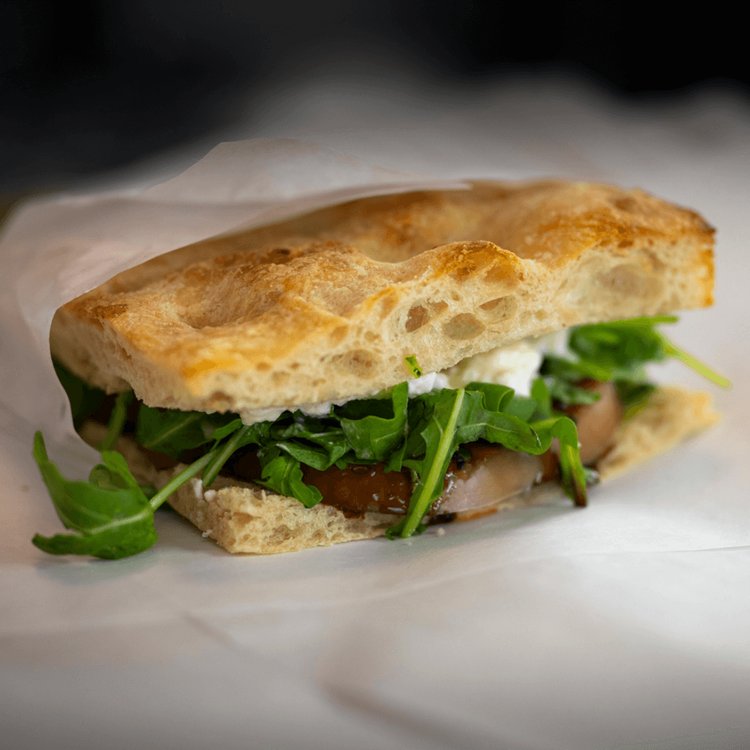 The Caprese — stracciatella, tomato, basil pesto, and black garlic balsamic